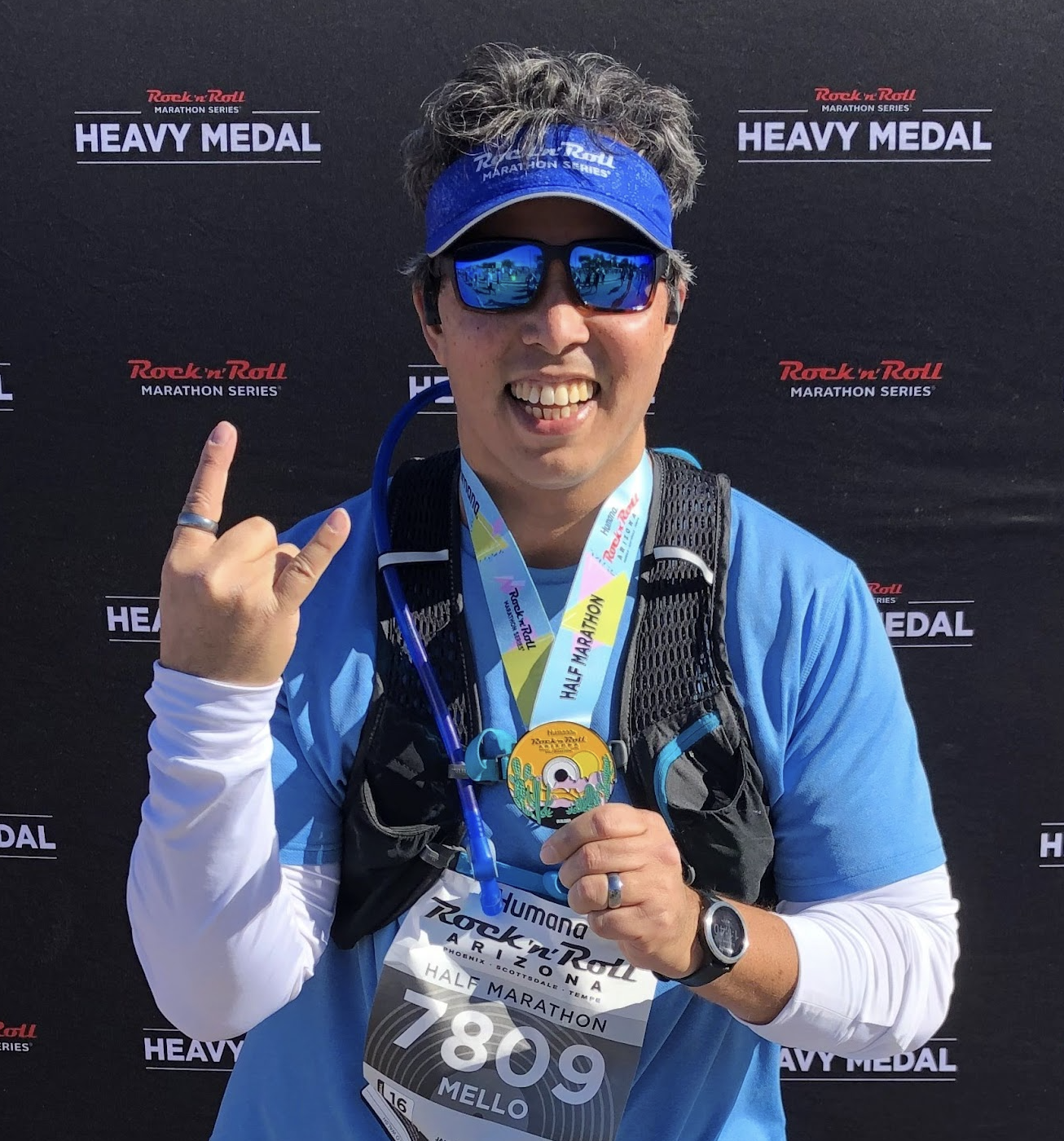 Carmelo showing off his medal from running a half marathon in 2020